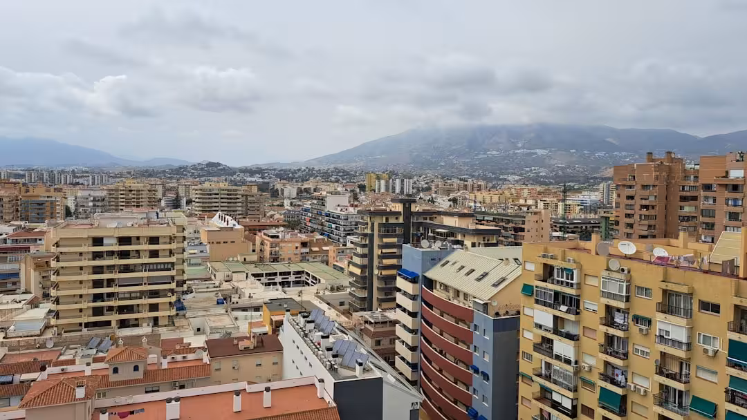 A view of a city with mountains in the background