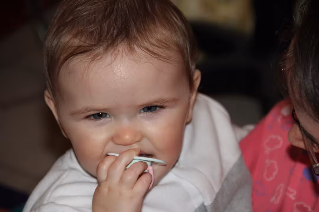 baby in white long sleeve shirt