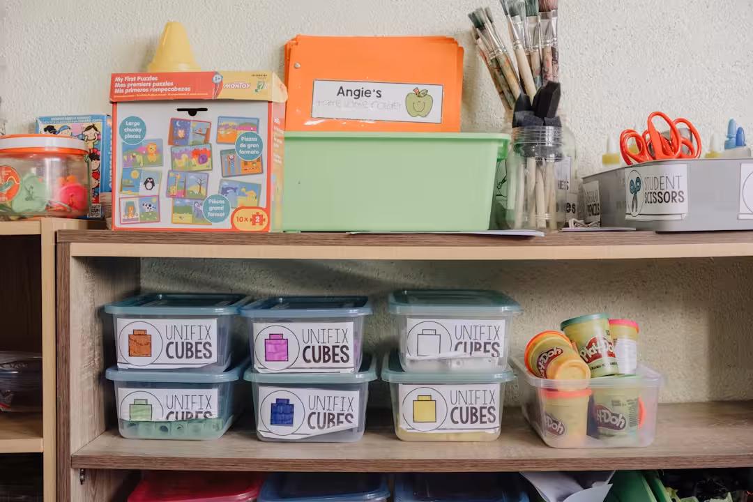 A wooden shelf filled with lots of craft supplies
