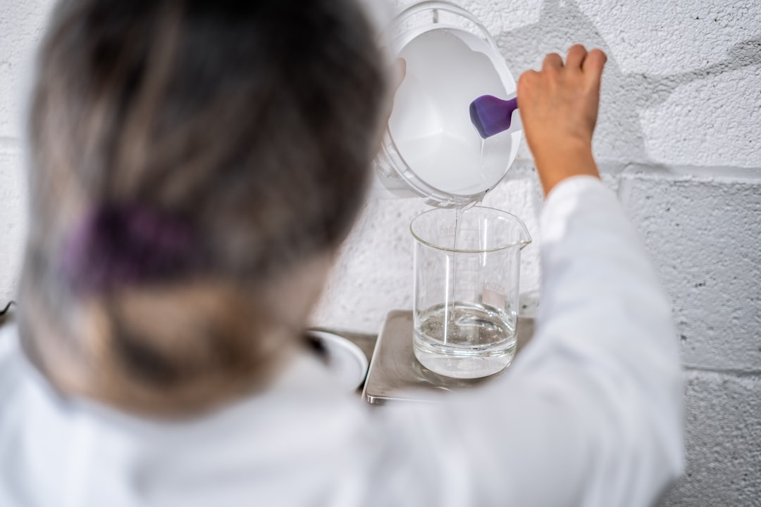 espacio Montessori - Niño vertiendo agua en un vaso de cristal con concentración