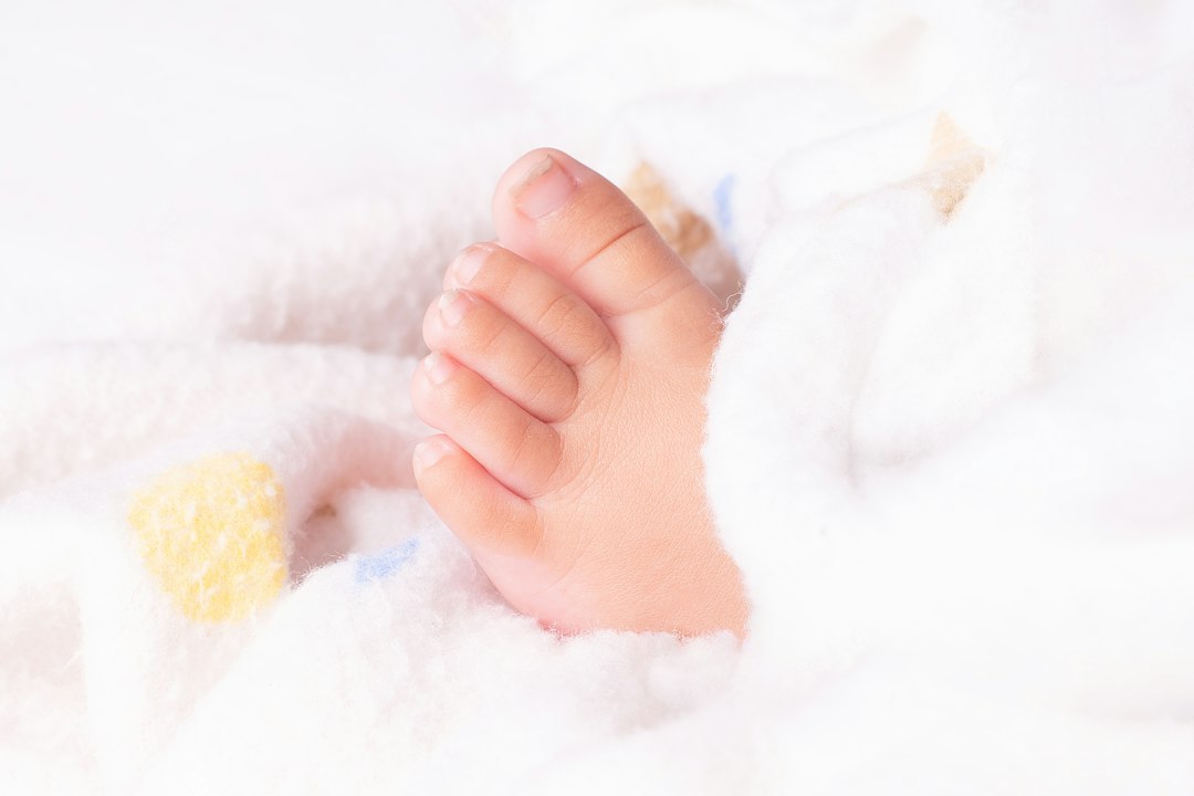 baby massage step by step - Close-up of a newborn baby's tiny foot
